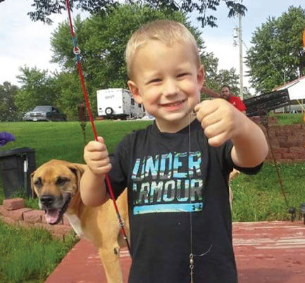 Little boy with fishing pole and dog