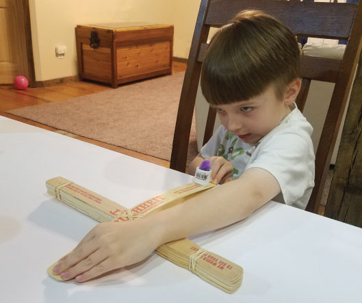 Little boy with homemade catapult